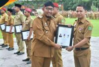 Foto:Sekdes Lenteng Timur, Deddy Setiadi, S.H. saat menerima penghargaan yang diberikan langsung oleh Bupati Sumenep, Achmad Fauzi