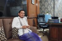 BERSARUNG : Kepala Dinsos Sumenep, Mustangin, saat ditemui wartawan seputarjatim.com di ruangan kerjanya (SandiGT - Seputar Jatim)