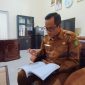 MEMBACA: Kepala BRIDA Sumenep, Benny Irawan saat memaparkan pokok permasalahan daerah di ruang kerjanya (SandiGT - Seputar Jatim)