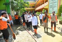 GERAK CEPAT: Wabup Sumenep, Imam Hasyim bersama BPBD Sumenep dan Forpimka usai memperbaiki pagar Ponpes Al Amien Prenduan, yang jebol akibat luapan banjir (Doc. Seputar Jatim)