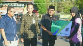 BAHAGIA: Bupati Sumenep, Achmad Fauzi Wongsojudo saat menyerahkan Kartu BPJS Ketenagakerjaan secara Simbolis kepada para Atlet Porprov 2025 (Doc. Seputar Jatim)