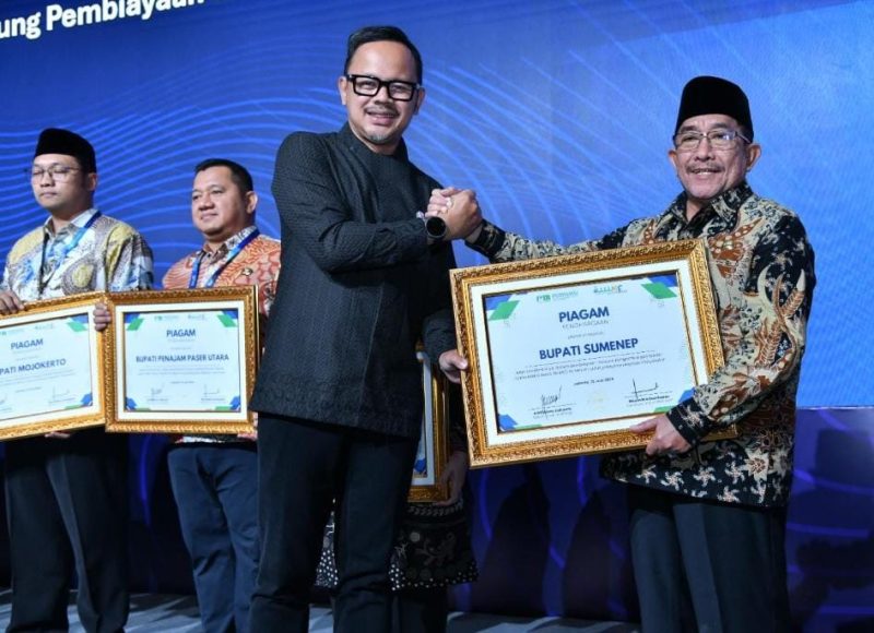 TERSEYUM: Wakil Bupati Sumenep, Imam Hasyim saat menerima penghargaan dari Wamen Dalam Negeri, Arya Bima di JCC  (Doc. Seputar Jatim)