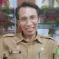 TERSENYUM: Kepala Bidang Persampahan DLH Sumenep, Deddy Surya, ketika berbicara tumpukan sampah di Sumenep (Doc. Seputar Jatim)