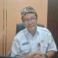 BERKACAMATA: Kepala Dinas Penanaman Modal dan Pelayanan Terpadu Satu Pintu Kabupaten Sumenep, Abd. Rahman Riadi, saat ditemui di kantornya (SandiGT - Seputar Jatim)