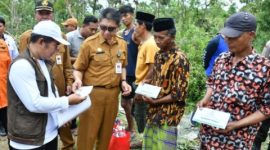 BANTUAN: Pj Sekretaris Daerah Kabupaten Sumenep, Syahwan Efendi (tengah) bersama Ketua Baznas Sumenep, saat memberikan bantuan kepada korban bencana angi puting beliung di Karduluk, Kecamatan Pragaan (Foto Istimewa)