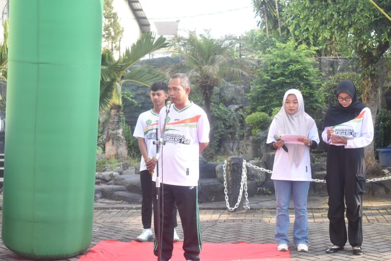 BERDIRI: Rektor UPI Sumenep, Asmoni, saat memberikan sambutan sekaligus melepas peserta Jalan-Jalan Sehat dalam rangka Dies Natalis ke-41 (SandGT - Seputar Jatim)